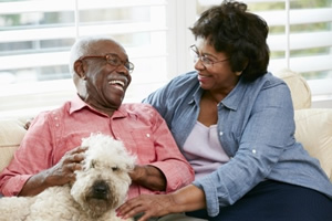 African-American older couple smiling with their dog; Estate Planning in Inglewood